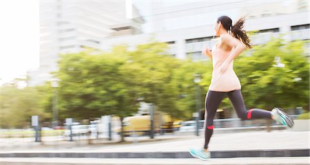 fit person running - Woman running through city streets Stock Photo - Premium Royalty-Free, Code: 6113-07790781