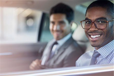 Smiling businessmen sitting in car Stock Photo - Premium Royalty-Free, Code: 6113-07790868