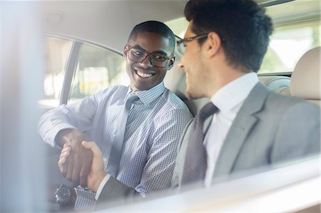 simsearch:6113-07790909,k - Smiling businessmen shaking hands in car Stock Photo - Premium Royalty-Free, Code: 6113-07790897