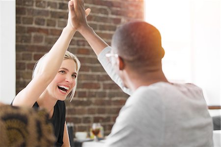 successful business woman arms raised with joy - Business people high fiving at meeting in cafe Photographie de stock - Premium Libres de Droits, Code: 6113-07790894