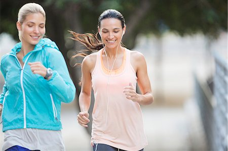 Women running through city streets together Fotografie stock - Premium Royalty-Free, Codice: 6113-07790819