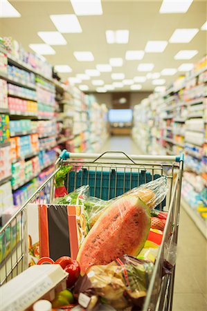 Full shopping cart in grocery store aisle Stock Photo - Premium Royalty-Free, Code: 6113-07791077