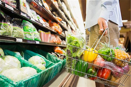fresh products - Man carrying full shopping basket in grocery store Stock Photo - Premium Royalty-Free, Code: 6113-07791148