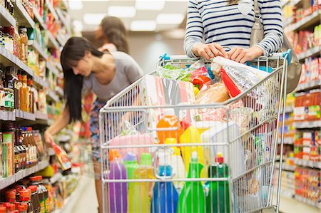 enjoy shopping food market - Woman pushing full shopping cart in grocery store Stock Photo - Premium Royalty-Free, Code: 6113-07791120