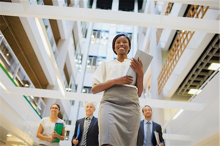 simsearch:6108-05868267,k - Business people walking in office building Stock Photo - Premium Royalty-Free, Code: 6113-07791243