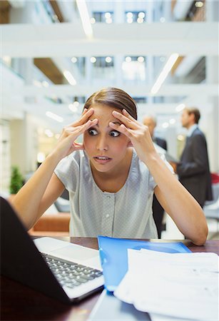 stress woman computer - Stressed businesswoman working in office building Stock Photo - Premium Royalty-Free, Code: 6113-07791290