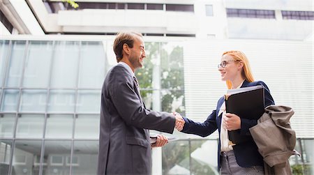 Business people shaking hands outside office building Stock Photo - Premium Royalty-Free, Code: 6113-07791393