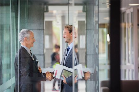 Businessmen shaking hands in office building Stock Photo - Premium Royalty-Free, Code: 6113-07791304