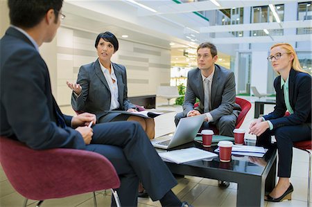 simsearch:6113-07542483,k - Business people talking in meeting in office building Stock Photo - Premium Royalty-Free, Code: 6113-07791338