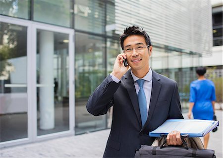 simsearch:656-04926491,k - Businessman talking on cell phone outside of office building Stock Photo - Premium Royalty-Free, Code: 6113-07791457