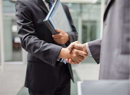 Businessmen shaking hands outdoors Stock Photo - Premium Royalty-Free, Code: 6113-07791465