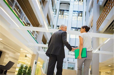 people office two man - Business people shaking hands in office building Stock Photo - Premium Royalty-Free, Code: 6113-07791427