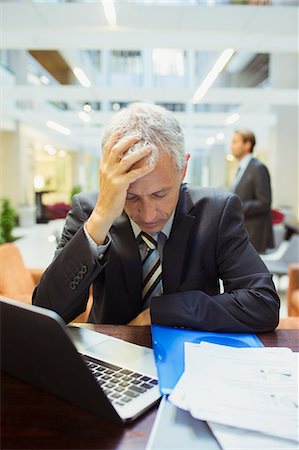 simsearch:693-03314173,k - Businessman resting while working in office building Stock Photo - Premium Royalty-Free, Code: 6113-07791424