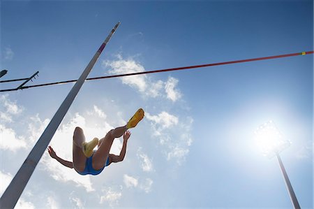simsearch:6113-07730603,k - Pole vaulter clearing bar Stock Photo - Premium Royalty-Free, Code: 6113-07730449