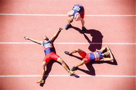 simsearch:632-05816125,k - Runners collapsing on track Photographie de stock - Premium Libres de Droits, Code: 6113-07730468