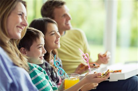 four dinner - Family watching television in living room Stock Photo - Premium Royalty-Free, Code: 6113-07730561