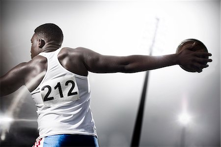 Track and field athlete throwing discus Stock Photo - Premium Royalty-Free, Code: 6113-07730500