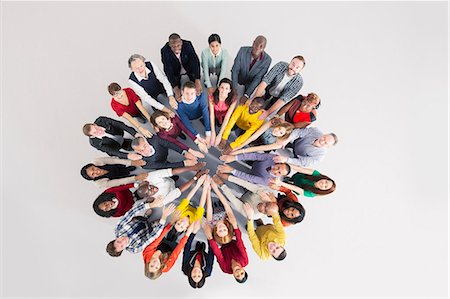 studio shot - Portrait of confident business people in huddle Stock Photo - Premium Royalty-Free, Code: 6113-07730675