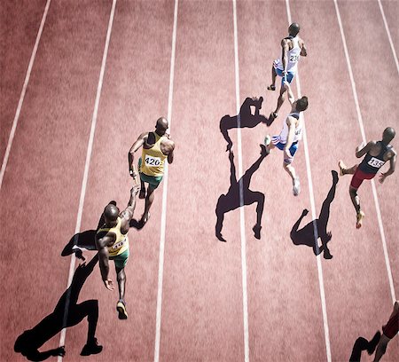 relay run - Relay runners handing off baton on track Stock Photo - Premium Royalty-Free, Code: 6113-07730610