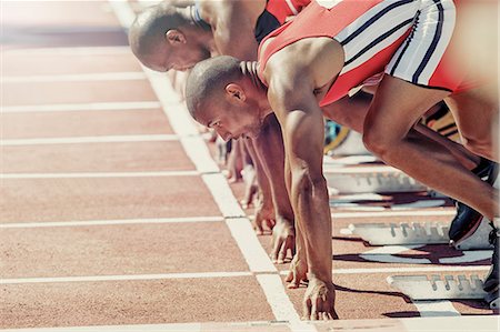 standing in a line - Runners ready at starting block Stock Photo - Premium Royalty-Free, Code: 6113-07730612