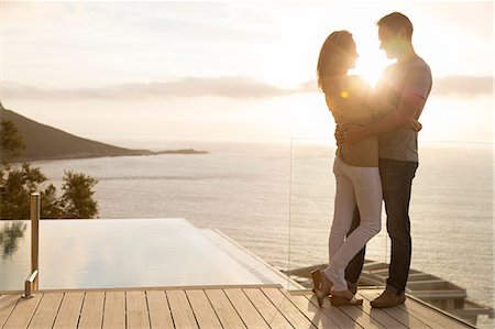 Couple on wooden deck overlooking ocean Foto de stock - Sin royalties Premium, Código: 6113-07730740