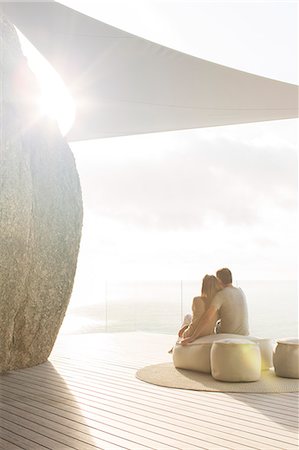 Couple relaxing together on modern balcony Foto de stock - Sin royalties Premium, Código: 6113-07730773