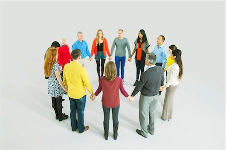 simsearch:6113-07730713,k - Business people holding hands in circle Stock Photo - Premium Royalty-Free, Code: 6113-07730718