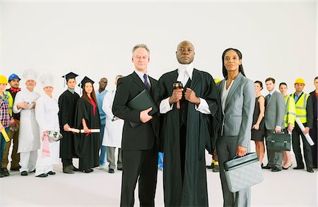 simsearch:6113-07730673,k - Workforce behind confident lawyers and judge Stock Photo - Premium Royalty-Free, Code: 6113-07730724