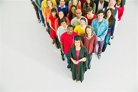 Diverse crowd behind confident graduate Stock Photo - Premium Royalty-Free, Code: 6113-07730725