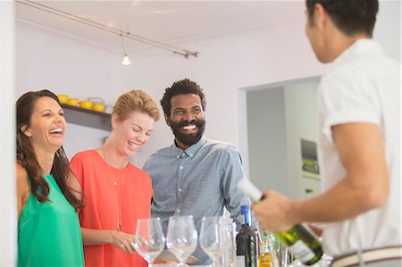 serving dinner - Friends laughing together at party Stock Photo - Premium Royalty-Free, Code: 6113-07730842