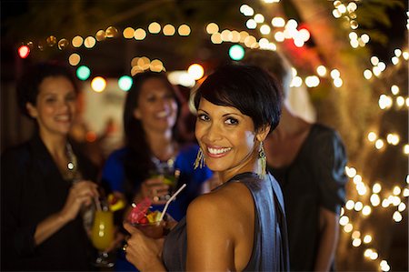 person drinking outside - Woman smiling at party Stock Photo - Premium Royalty-Free, Code: 6113-07730860