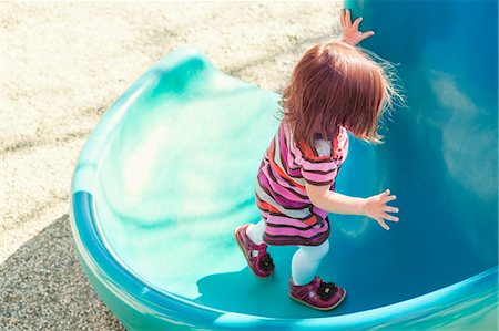 Baby girl climbing slide at playground Stock Photo - Premium Royalty-Free, Code: 6113-07730809
