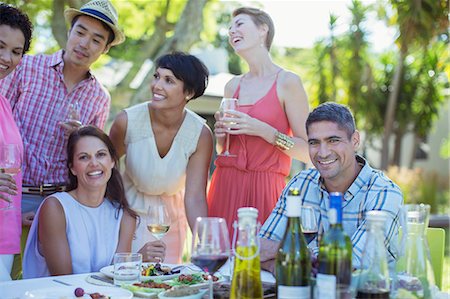 simsearch:6113-07731035,k - Friends relaxing at table outdoors Stock Photo - Premium Royalty-Free, Code: 6113-07730942