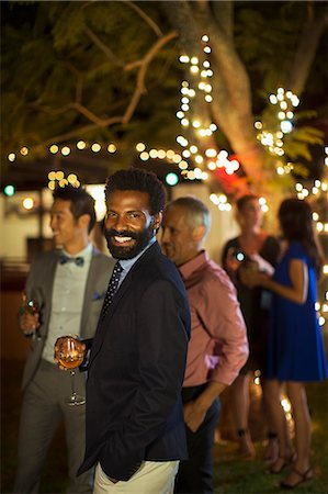 simsearch:6113-07730999,k - Man laughing at party Stock Photo - Premium Royalty-Free, Code: 6113-07730977