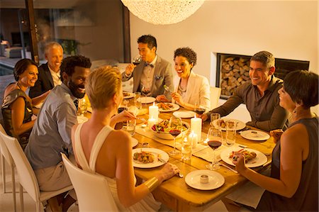 party indoors night - Friends talking at dinner party Stock Photo - Premium Royalty-Free, Code: 6113-07730981