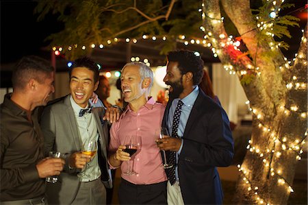 four people - Men talking at party Stock Photo - Premium Royalty-Free, Code: 6113-07730905