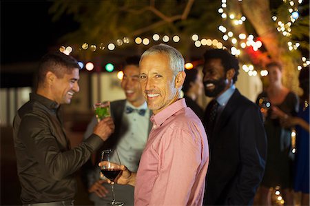 people drinking party - Man smiling at party Stock Photo - Premium Royalty-Free, Code: 6113-07730923