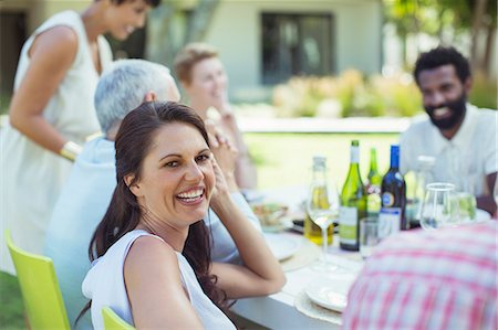simsearch:6113-07730981,k - Woman smiling at table outdoors Stock Photo - Premium Royalty-Free, Code: 6113-07730931