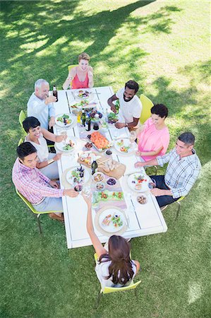 Friends eating together at table outdoors Stock Photo - Premium Royalty-Free, Code: 6113-07731032