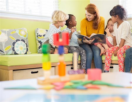 Teacher and students reading in classroom Stock Photo - Premium Royalty-Free, Code: 6113-07731135