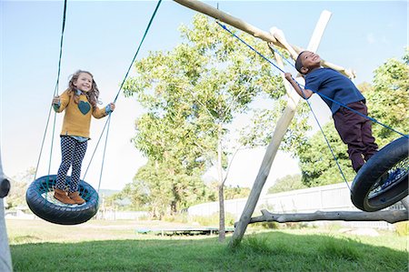 simsearch:6113-07731259,k - Children playing on tire swings Foto de stock - Royalty Free Premium, Número: 6113-07731254