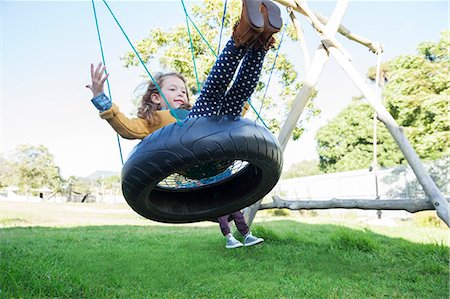 descending - Children playing on tire swings Stock Photo - Premium Royalty-Free, Code: 6113-07731283