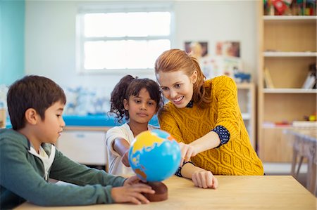 early childhood educator - Students and teacher examining globe in classroom Stock Photo - Premium Royalty-Free, Code: 6113-07731281