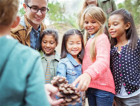 simsearch:6113-07731196,k - Students and teacher examining pine cone in forest Stock Photo - Premium Royalty-Free, Code: 6113-07731282