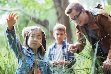 simsearch:6113-07731282,k - Students and teacher examining grass in forest Stock Photo - Premium Royalty-Free, Code: 6113-07731289