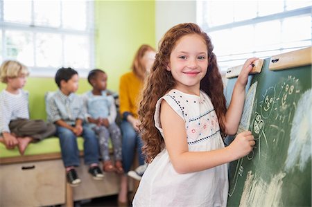 Student drawing on chalkboard in classroom Stock Photo - Premium Royalty-Free, Code: 6113-07731207