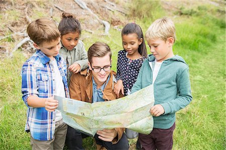 Students and teacher reading map outdoors Stock Photo - Premium Royalty-Free, Code: 6113-07731224