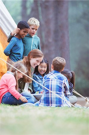 simsearch:6113-07731136,k - Students and teacher reading at campsite Photographie de stock - Premium Libres de Droits, Code: 6113-07731306