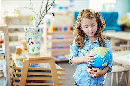 daycare center - Student examining globe in classroom Stock Photo - Premium Royalty-Free, Code: 6113-07731322