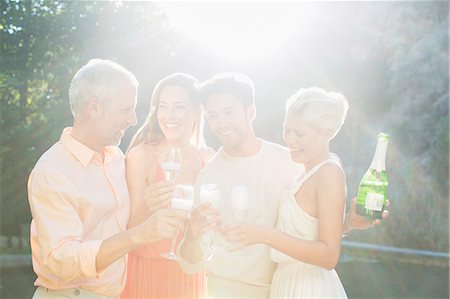 four people cheers - Friends toasting each other with champagne outdoors Stock Photo - Premium Royalty-Free, Code: 6113-07731664